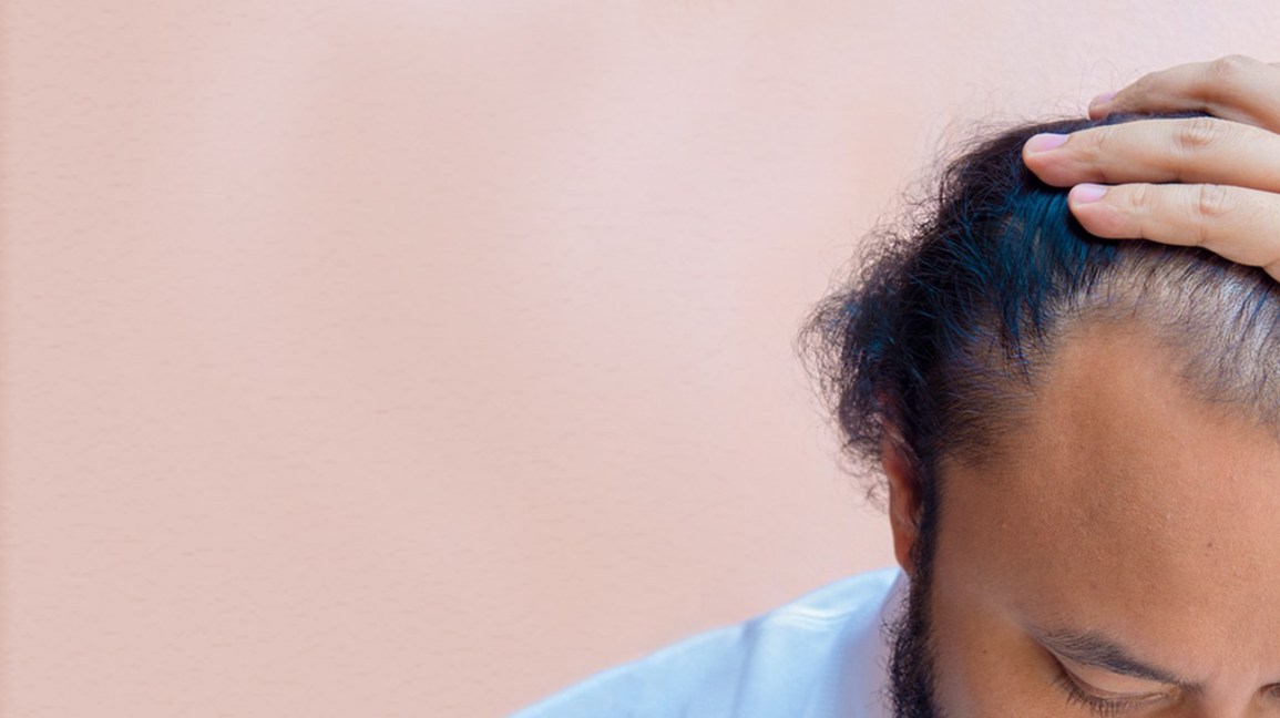 man with hand on his hair 1296x728 header